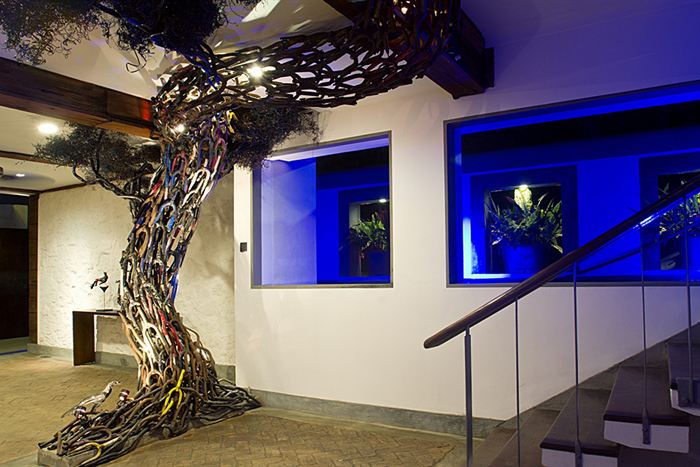 The tree sculpted from bicycle parts rising past a staircase inside Colombo Court.