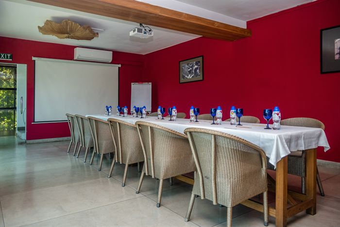 The Scarlet Room set with a long table and chairs for a meeting.