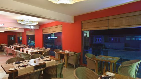 The Scarlet Room at Colombo Court, a long table laid out for a meeting under warm light.