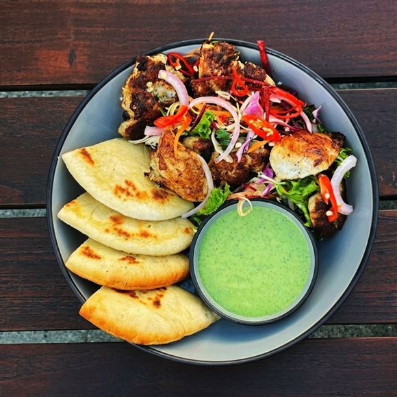 Turkish seekh kebab with flatbread and a green chutney.