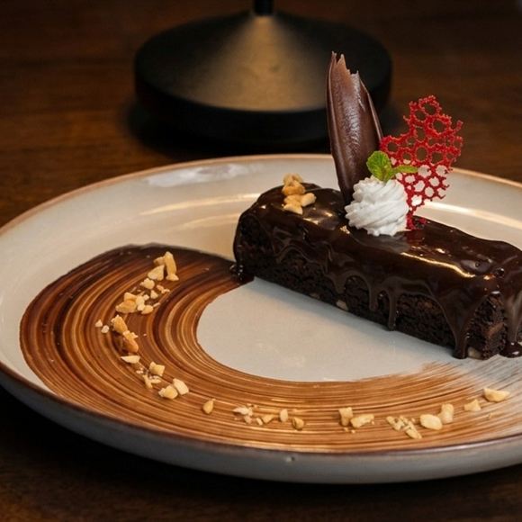 Brownie fantasy, a chocolate dessert plated with sauce.