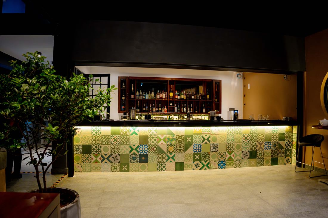 The bar at Cloud Caf&eacute; & Bar, faced in patterned Ceylon cement tiles.