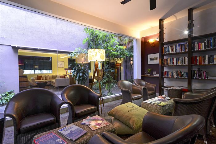 The library at Colombo Court, floor to ceiling shelves with leather chairs and reading lamps.