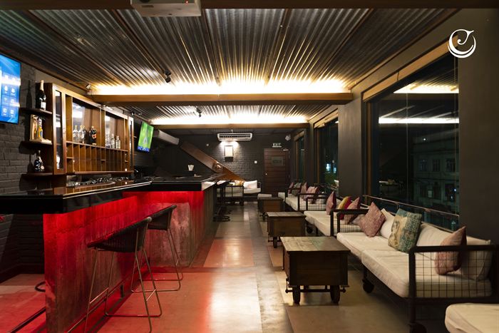 The Loft bar and lounge, a lit red counter with low banquette seating along the wall.
