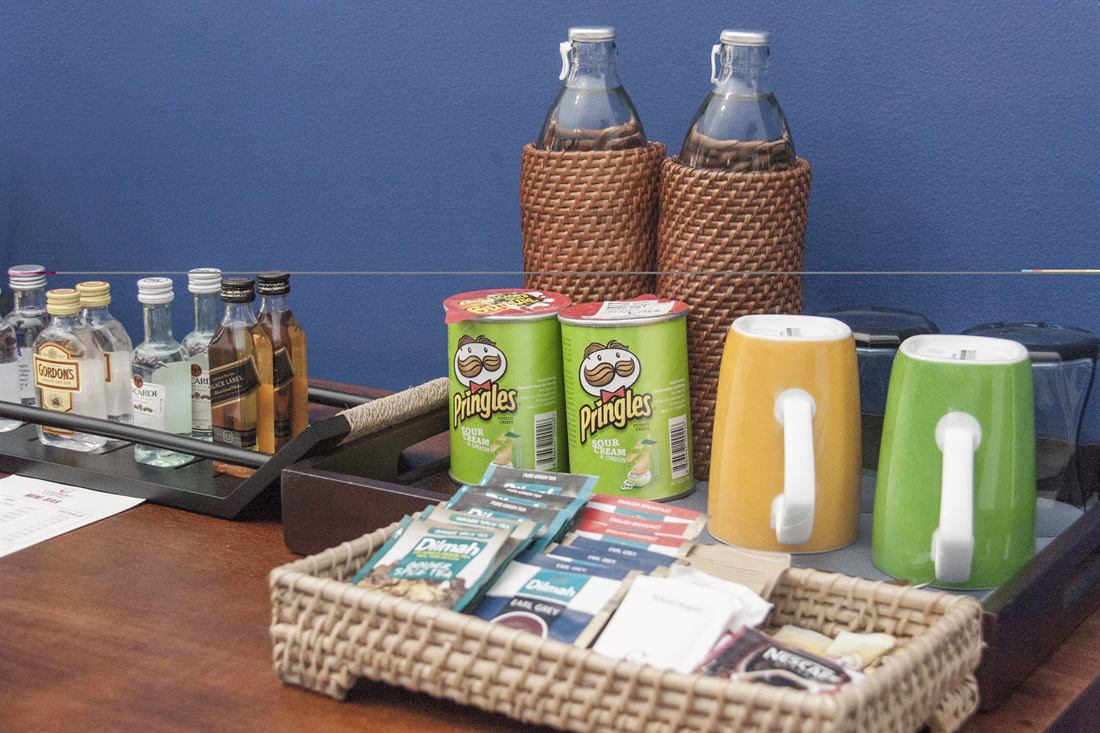 The minibar tray in the Luxury Honeymoon Suite, glass bottles and a flask.