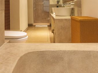 The bathroom in a Luxury Junior Suite, a stone bath beside a walk-in rain shower.
