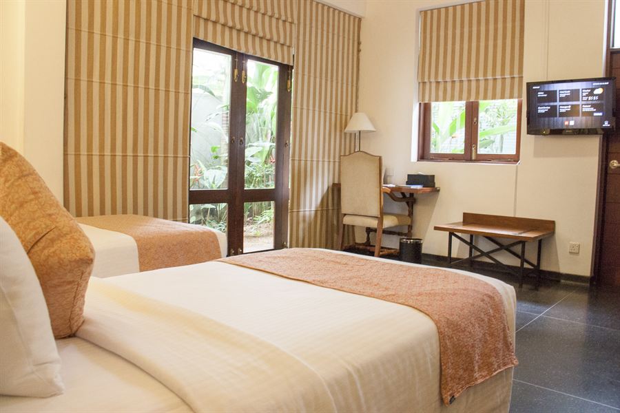 A Deluxe Twin room, two beds and a window onto the trees.