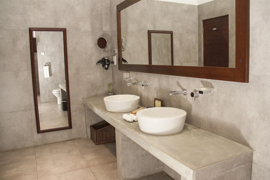 The bathroom in a Deluxe Twin room, twin basins on a stone counter.