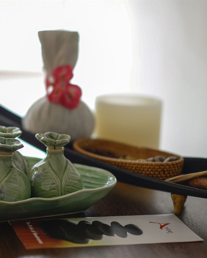 Herbal compresses, oils and a lit candle laid out before a treatment at The Court Spa.
